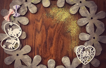 Easter card, on a background of natural wood with bows, flowers and Easter decorations.