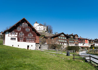 Fototapeta na wymiar Werdenberg, SG / Switzerland - March 31, 2019: historic Werdenberg village and castle with traditional Burgher homes with wall art and painting
