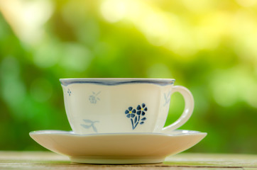 Cup of  hot tea on table in the garden ,relax time.