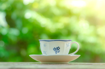 Cup of  hot tea on table in the garden ,relax time.