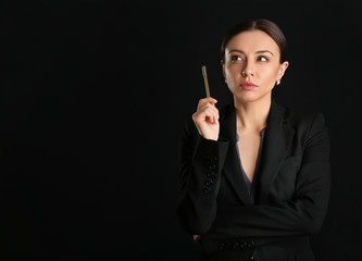 Stylish businesswoman on dark background