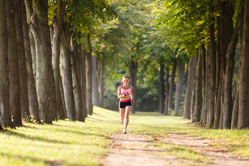 sport girl making exercises outdoors. Young sport woman in a park. Sport and fitness on open air. Exercise lunge leg on the grass and stretching