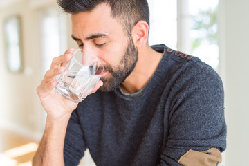 Handsome man drinking a fresh glass of water