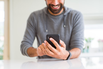 Close up of man using smartphone smiling
