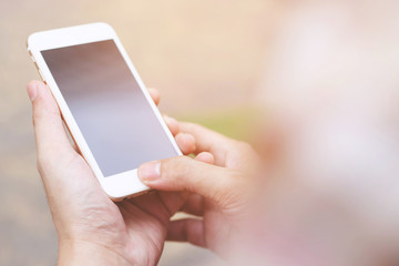 close up people man of hand holding white mobile smart phone with blank empty screen. empty space for text. Technology concept.
