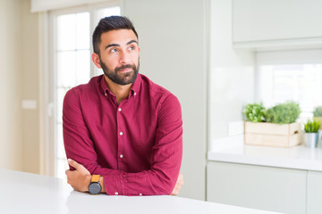 Fototapeta premium Handsome hispanic business man smiling looking side and staring away thinking.