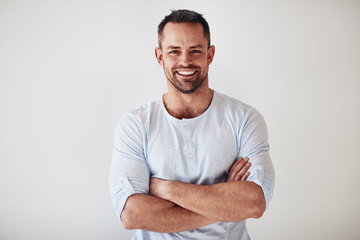 Mature entrepreneur standing with arms crossed on a white backgr