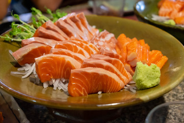 Raw salmon slice or salmon sashimi in Japanese style fresh serve with fresh wasabi.