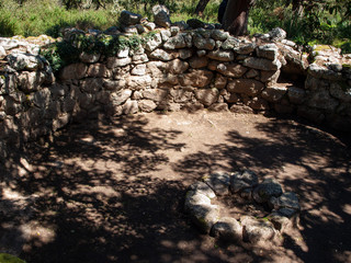megalithic circle and large circular hut in the archaeological site of Noddule - Nuoro Sardinia , ITALY.