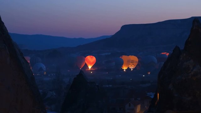 Hot air baloons preparing for take off. Famous sightseeing Cappadocia. Lights of air balloons.