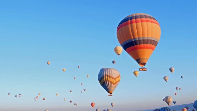 hot-air balloons flying over the mountain landsape of Cappadocia,Turkey.