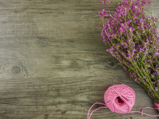 Flat lay,top view  wooden desk with stationery including notebook and pencil with a cup of coffee,flowers and copy space