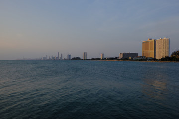 Fototapeta premium View of the sunset city from the pier in Pattaya