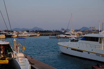 Fototapeta premium View of the sunset city from the pier in Pattaya