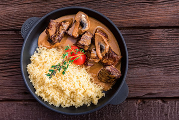 Top view mushroom beef stroganoff in frying pan with millet