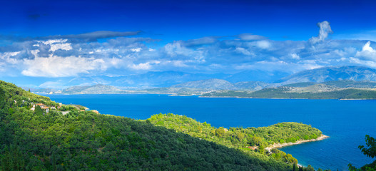 Fototapeta na wymiar Beautiful summer panoramic seascape. Green slopes in close bays with crystal clear azure water. Coastline of north part Corfu island, Ionian archipelago, Greece.