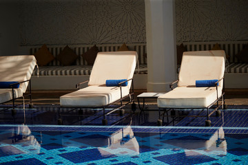 Obraz na płótnie Canvas Resort hotel pool side chairs