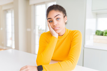 Beautiful young african american woman with afro hair thinking looking tired and bored with depression problems with crossed arms.