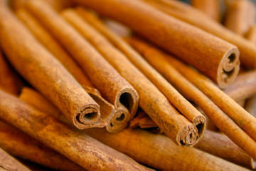 Bunch of cinnamon sticks, close up, focus, blurred background 