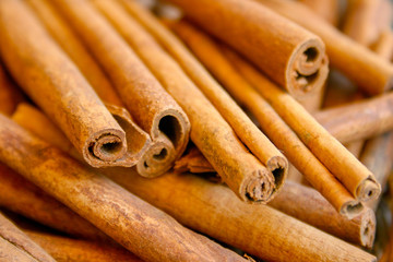 Bunch of cinnamon sticks, close up, focus, blurred background 