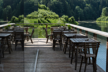 Holzmöbel auf Terrasse spiegeln sich in Glasfront