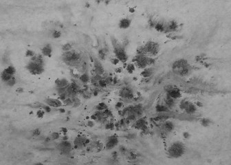 A black and white image of ink spots on wet paper