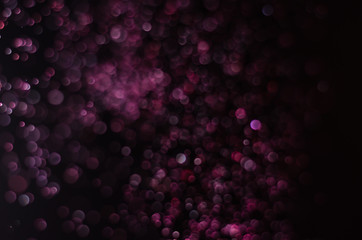 abstract bright colorful violet and red bokeh glitter sparkle blurred background. like molecule...