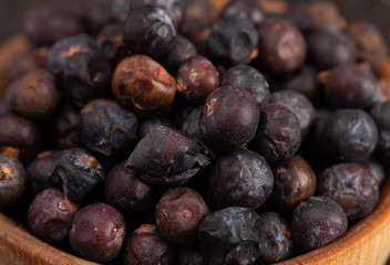 Bowl Full of Dried Juniper Berries on a Wooden Table