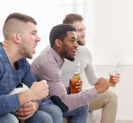 Men watching football, cheering for favourite team