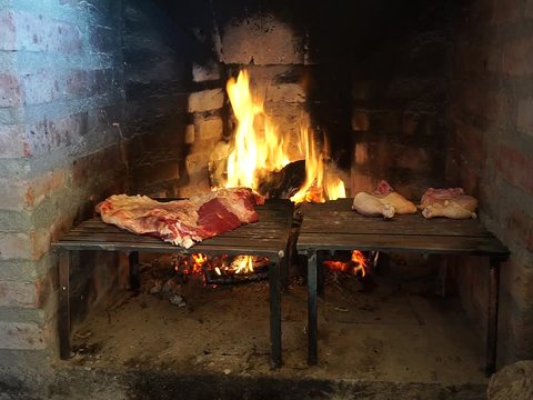 Cooking meat and chicken on a grill. Traditional Asado in Argentina