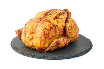 Roasted crispy chicken on round dish over white background