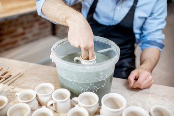 Painting clay jugs at the pottery