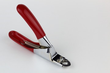 Tool for trimming claws pet stainless steel with red handles.