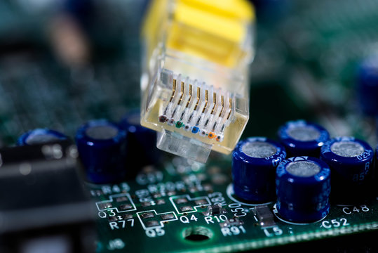 Yellow internet switch on computer circuit board close up macro shot, image for background, copy space.