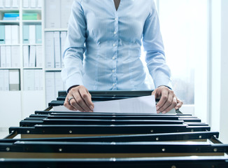 Office worker searching files in the archive