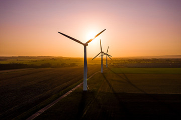 Aerial view of a wind farm during a dramatic sunrise in the English countryside, England