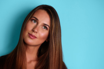 Naklejka premium Serious, confident young girl looking straight, isolated on blue background. Psychology, body language concept