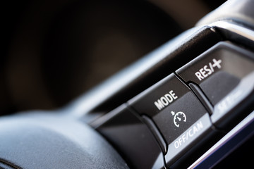 Speed Limiters, close up of the buttons and dials in a car for the speed limiting technology,...