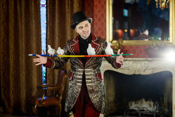 magician holds on forgive pigeons. The trainer of pigeons. Magic performance with pigeons