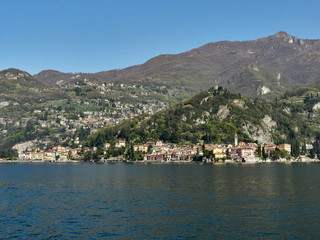 Fototapeta na wymiar Varenna, Italy March 30 2019 Far Frontal Lanscape view of Varenna Town and its surroundings at Lake Como Italy