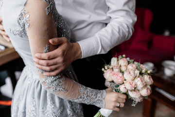 The groom holds his beloved hand