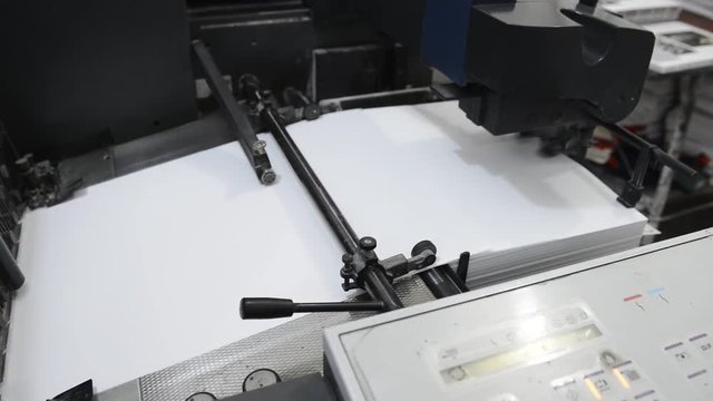 Print plant factory. Magazine printing at a plant. Newspaper printed on a printing house machine