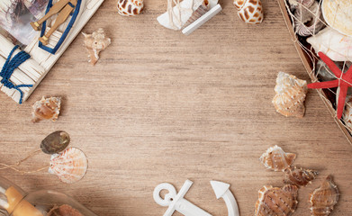 Rustic wooden background decorated with seashells with empty space in the middle