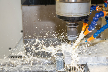 The  CNC milling machine cutting the mould part with the solid ball end mill tool and cooling by...