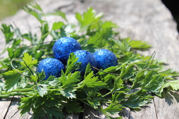 Blue shiny Easter eggs in green herbs nest
