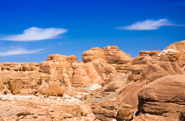 Fototapeta premium peaks of high stone rocks against a blue sky in Egypt Dahab South Sinai