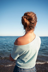 Young beautiful teenage girl contemplating Mediterranean Sea