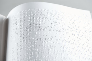 close up view of book with braille text isolated on grey