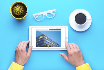 Man holds a tablet and looks at the screen. Mobile development. Innovational online businesses....