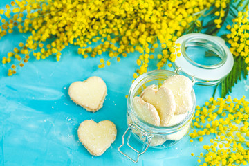 Heart shaped cookies with coconut chips in glass jar